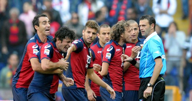 Kakha Kaladze: The defender is restrained by his team-mates after being sent off