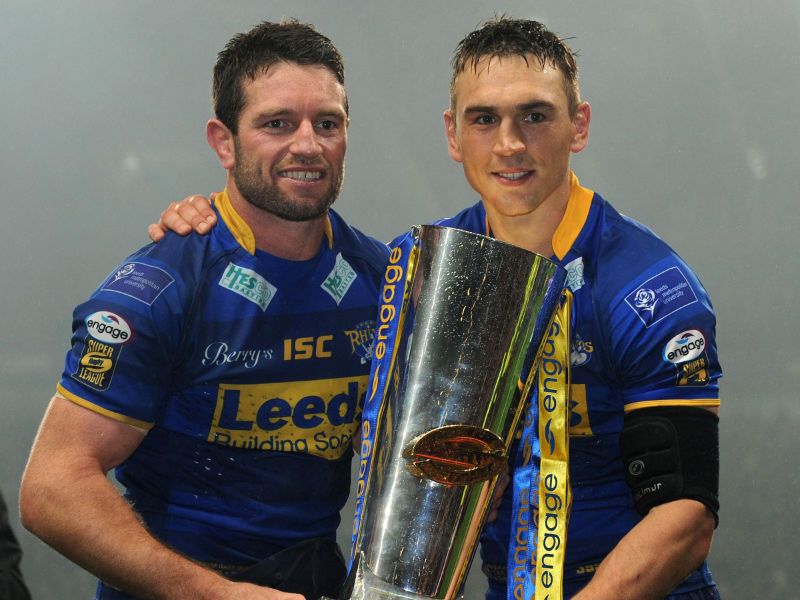 Danny Buderus and Kevin Sinfield celebrate with the spoils after Leeds' 32-16 win over St Helens at Old Trafford.