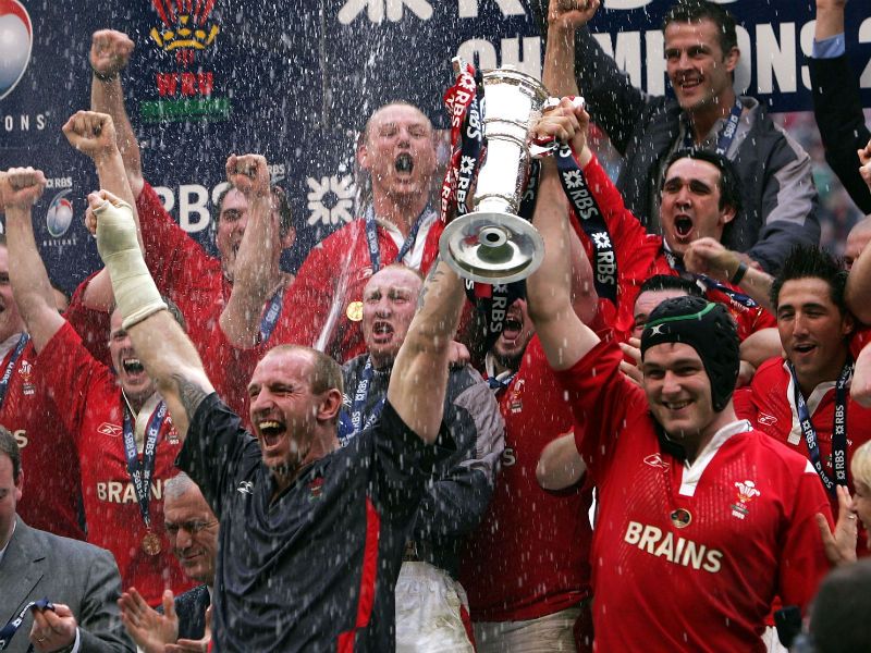Happier times were to follow in 2005 as Thomas (in grey holding trophy) was a part of the Grand Slam winning Wales side.