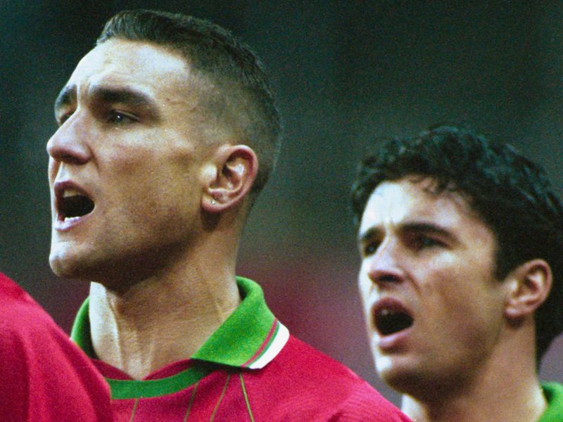 Speed sings the national anthem as Vinnie Jones prepares to make his Wales debut in 1994