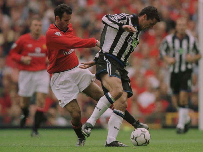 Speed does battle with fellow Wales great Ryan Giggs at Old Trafford in August 2000