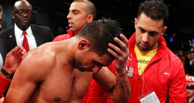 Amir Khan shows his disappointment after losing his WBA and IBF light-welterweight titles