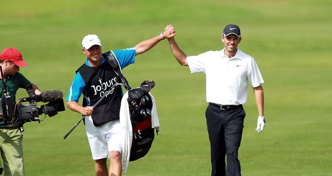 Charl Schwartzel celebrates with his caddie as he prepares to wrap up last year's event