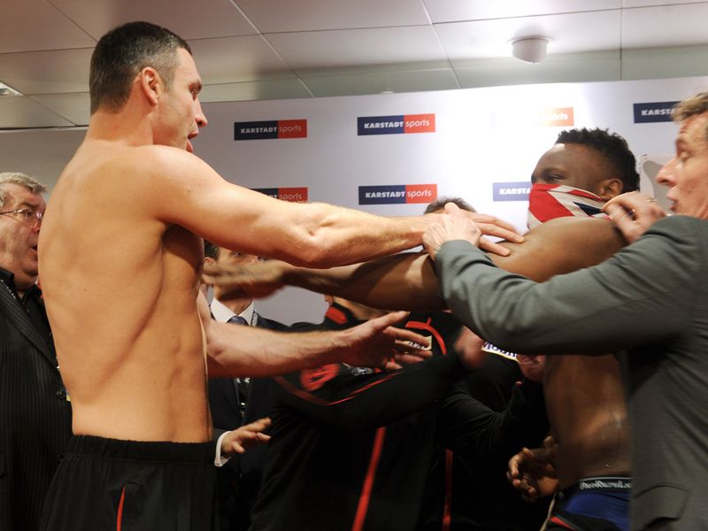 Klitschko reacts angrily to a slap in the face from Chisora