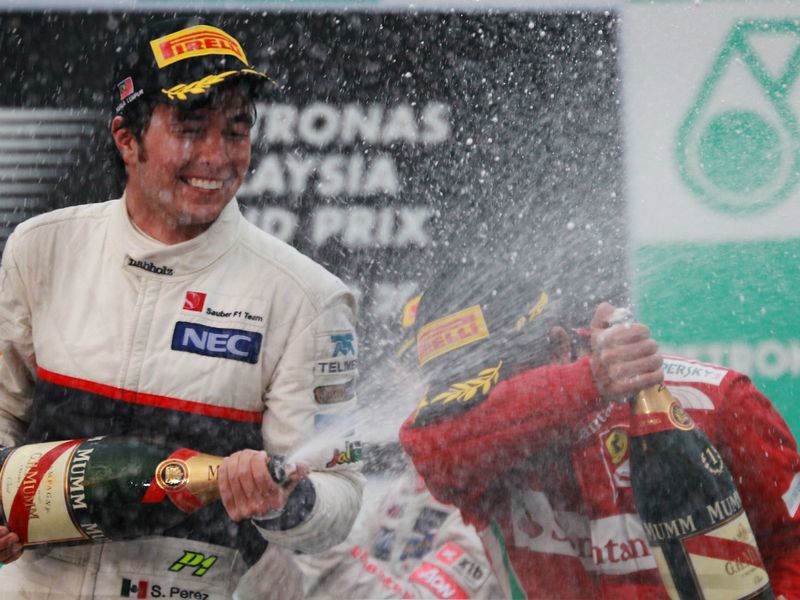 Sergio Perez sprays Fernando Alonso on the podium
