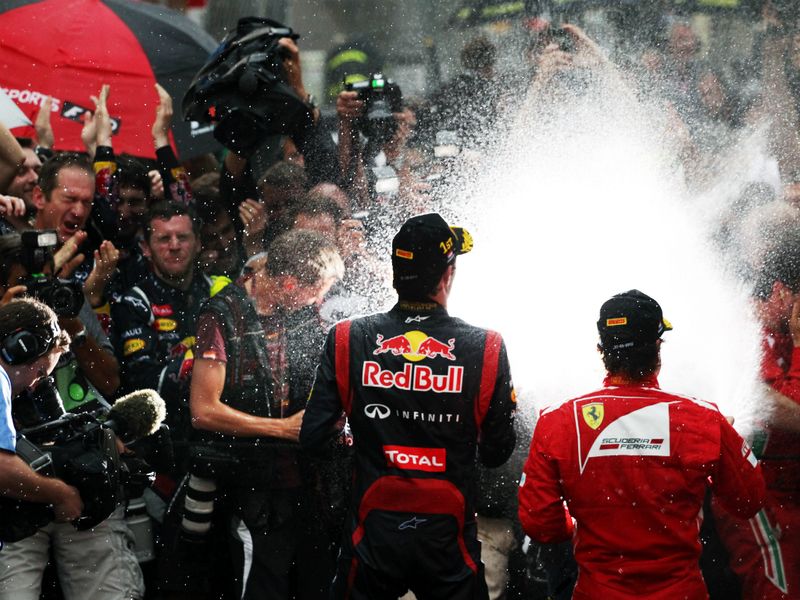 Mark Webber and Fernando Alonso spray the bubbly