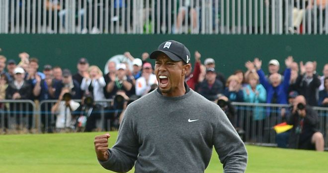 Tiger Woods holes out from a bunker at the 18th to close within four of the lead