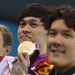 Sun Yang of China holds up the gold medal after winning the Men's 400m freestyle.