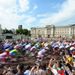 The peloton streams past Buckingham Palace in a blur of colour