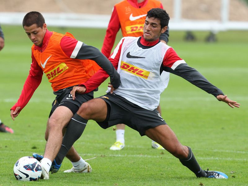 Frederic Veseli tries to tackle Javier Hernandez