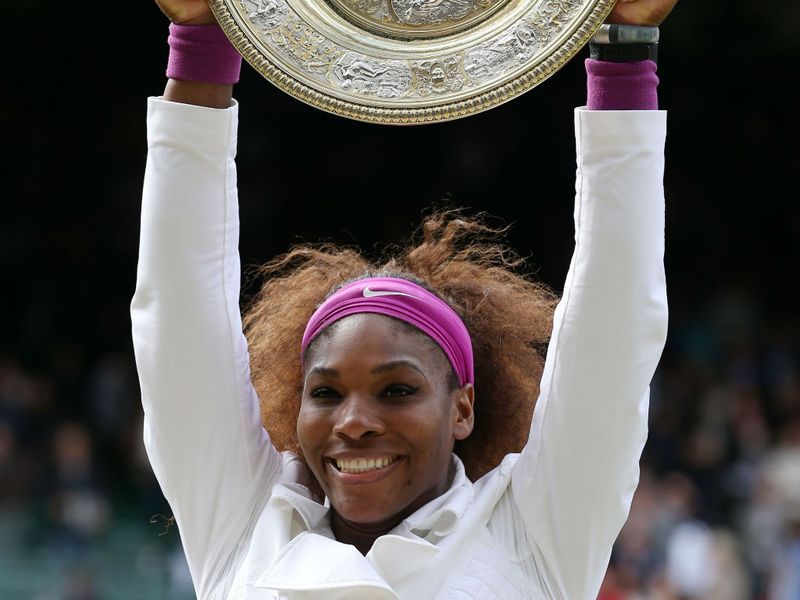 Serena holds the trophy aloft