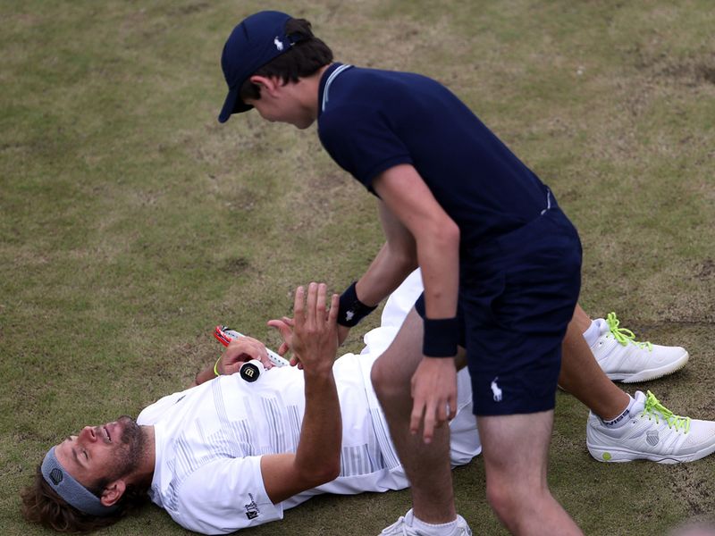 Mardy Fish took a tumble against Jo-Wilfried Tsonga and was helped up by a nearby ballboy.