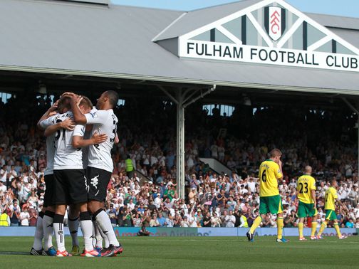Alex Kacaniklic is mobbed after scoring