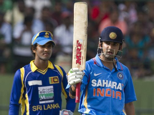 Gautam Gambhir salutes the crowd after reaching 50