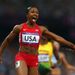 Carmelita Jeter points to the clock, as she realises that the USA Women's 4x100m team have won Gold and set a new World Record