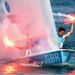 GB's Luke Patience and Stuart Bithell let off flares as they celebrate  winning the silver medal in the men's 470 sailing class.
