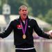 Tunisia's Oussama Mellouli celebrates with his gold medal following the men's marathon 10km swim.
