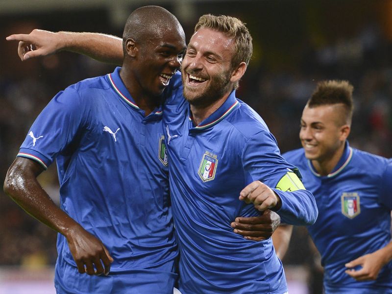 De Rossi celebrates his goal with Azzurri teammate defender Angelo Ogbonna.