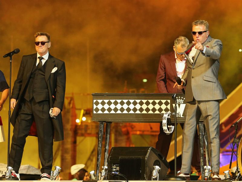 Madness are next to take centre stage, as Sugs starts an 80,000 person knees up with "Our House"