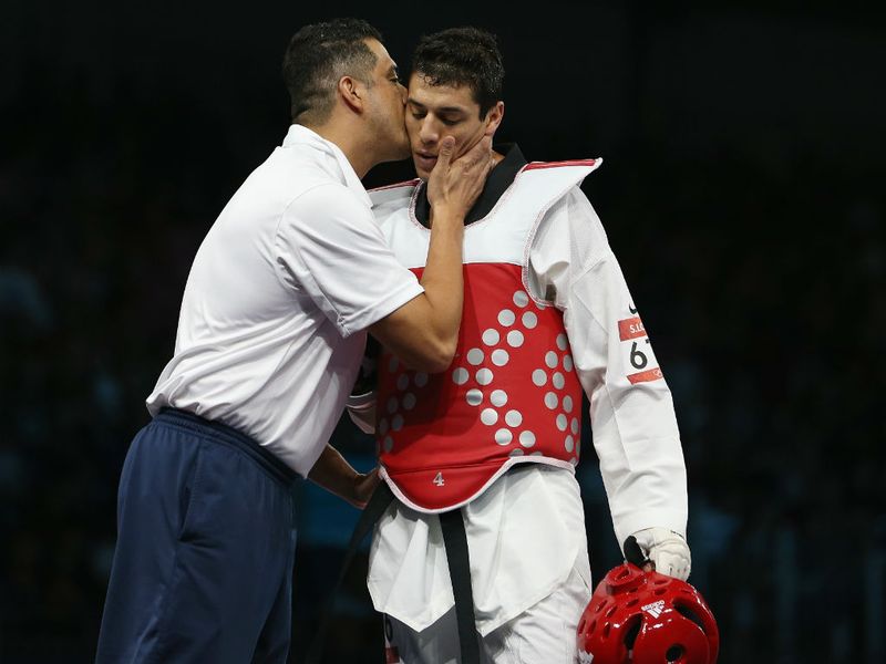 USA's Steven Lopez is comforted after losing to Ramin Azizov of Azerbaijan in the men's -80kg taekwondo preliminary round.