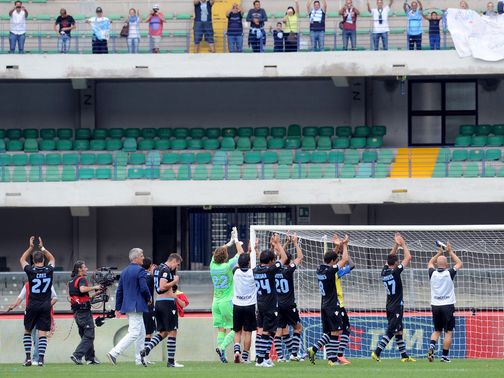 Lazio players applaud their travelling support