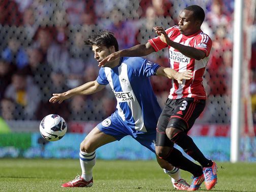Jordi Gomez holds off Danny Rose