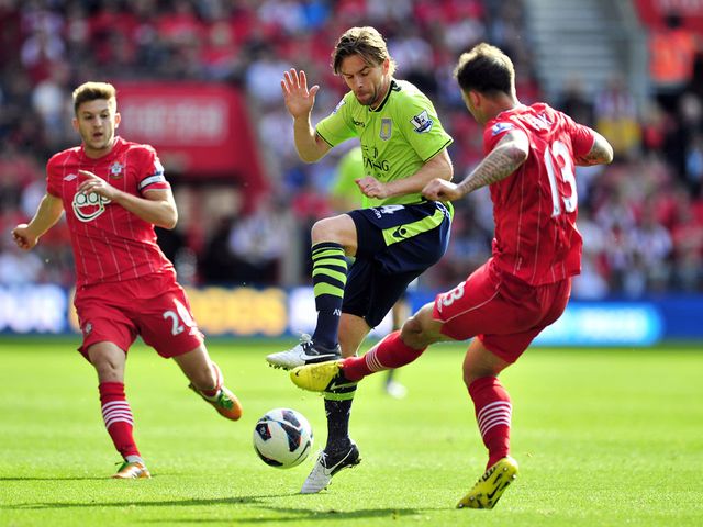 Brett Holman goes in for a tackle on Danny Fox