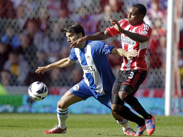 Jordi Gomez holds off Danny Rose