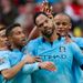 Lescott is mobbed after hitting the net