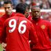Luis Suarez and Patrice Evra shake hands before the game