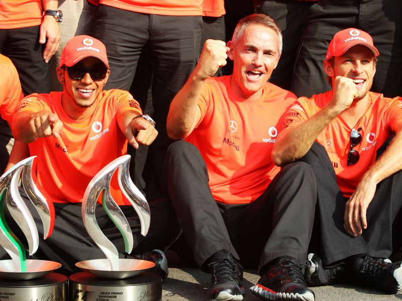 Lewis Hamilton celebrates with Martin Whitmarsh and Jenson Button