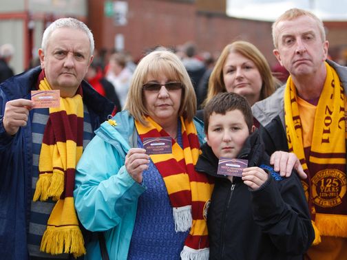 Motherwell fans with their match abandoned vouchers.
