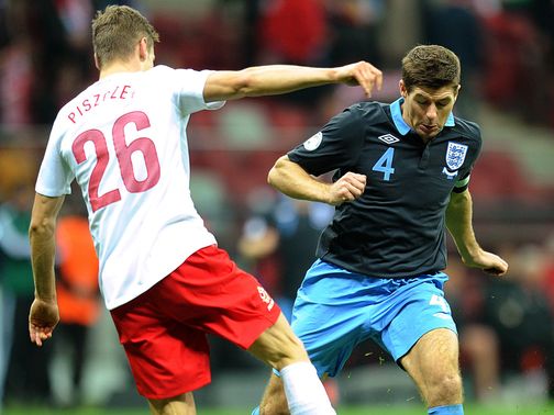 Steven Gerrard takes on Lukasz Piszczek