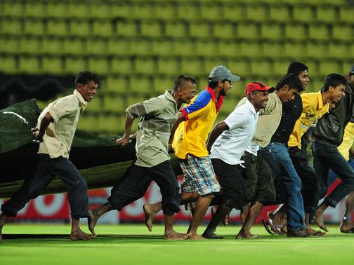 The covers come on as rain forces the match to be abandoned