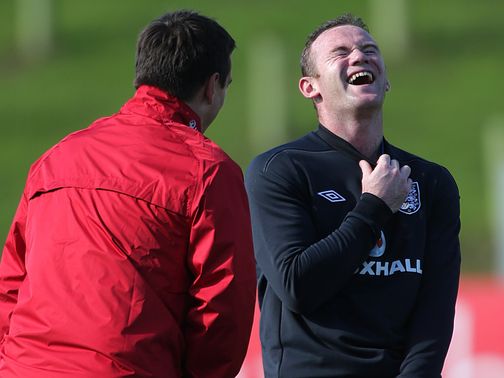 Wayne Rooney shares a joke with Gary Neville