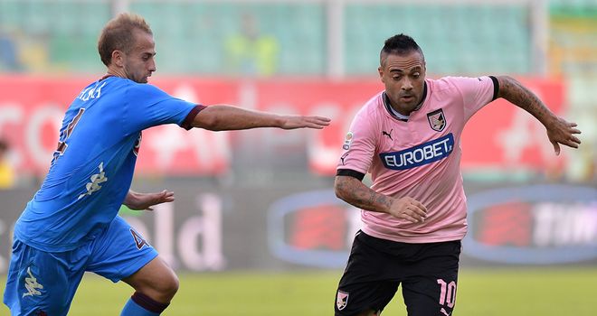 Migjen Basha and Fabrizio Miccoli battle for the ball