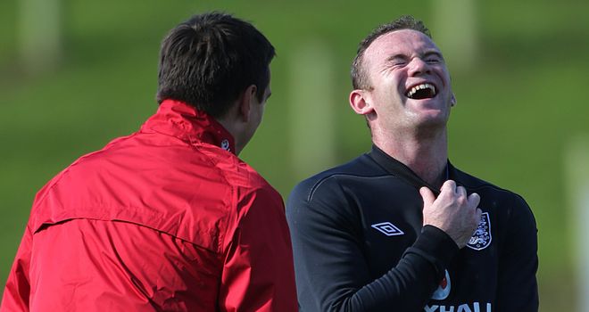 Wayne Rooney shares a joke with England coach Gary Neville