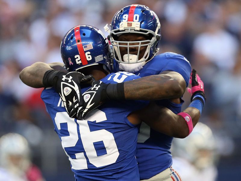 Antrel Rolle (No 26) and Jason Pierre-Paul celebrate a big play during the Giants' win over the Cowboys
