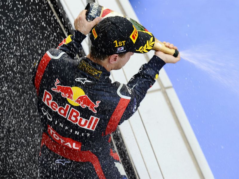 Vettel soaks the crowd below the podium