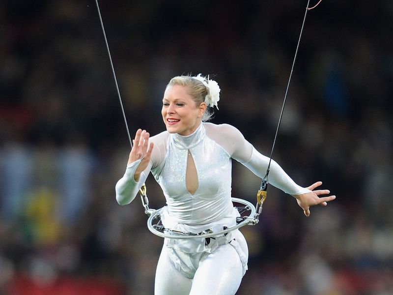 A performer on a high wire entertains the crowd before kick-off