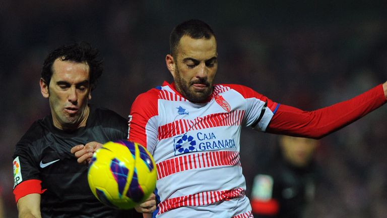 Diego Godin battles for the ball