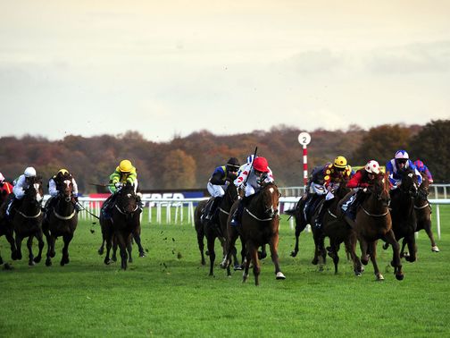 Desert Creek (white cap, red spots) wins the opener