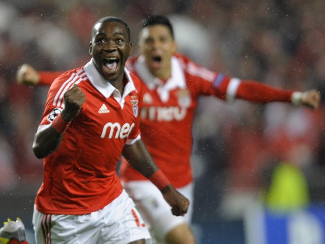 Ola John celebrates his early goal for Benfica