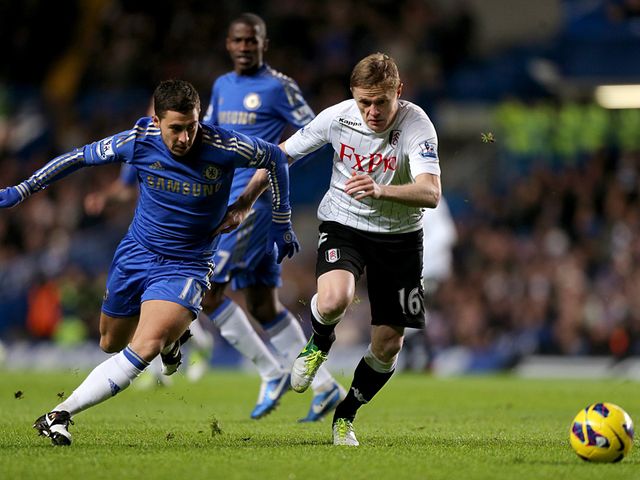 Eden Hazard and Damien Duff battle for the ball