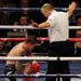 Referee John Keane calls an end to the fight after Hatton fails to regain his feet after 10 seconds