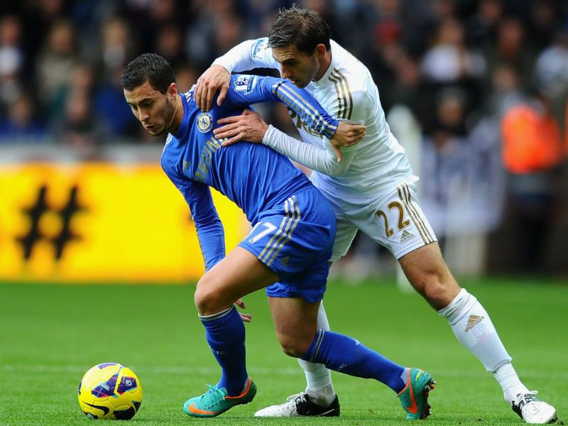 Giving their all: Eden Hazard of Chelsea battles with Swansea's Angel Rangel