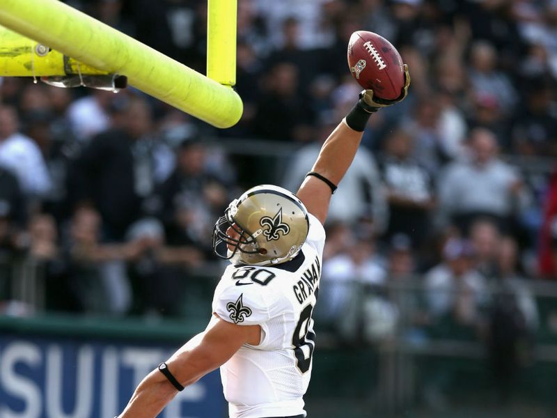 Jimmy Graham attempts a slam dunk after scoring a touchdown for the Saints