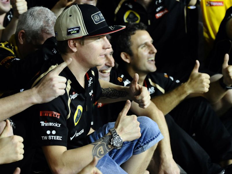 The Lotus team celebrate Raikkonen's victory