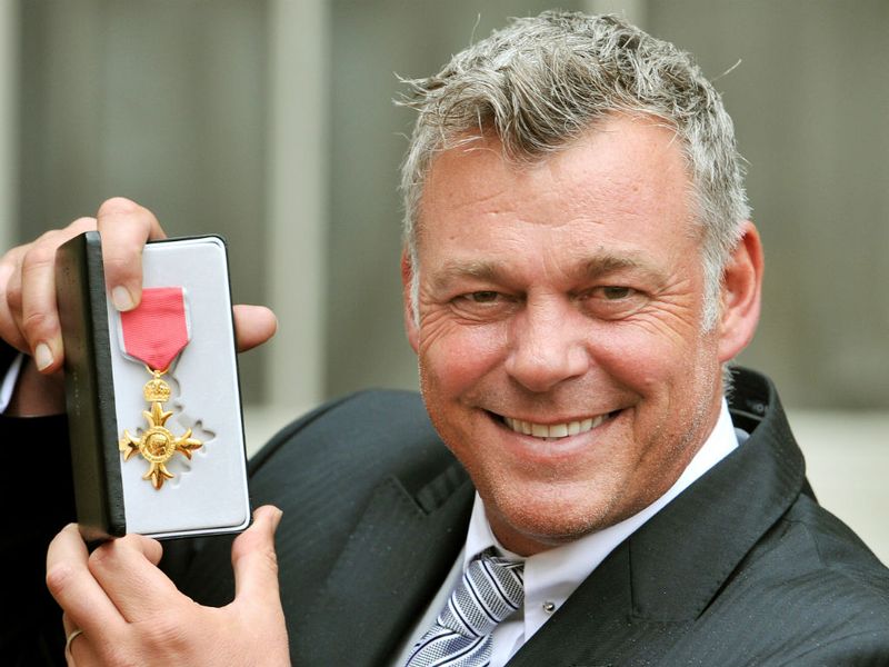 Clarke shows off his OBE at Buckingham Palace.