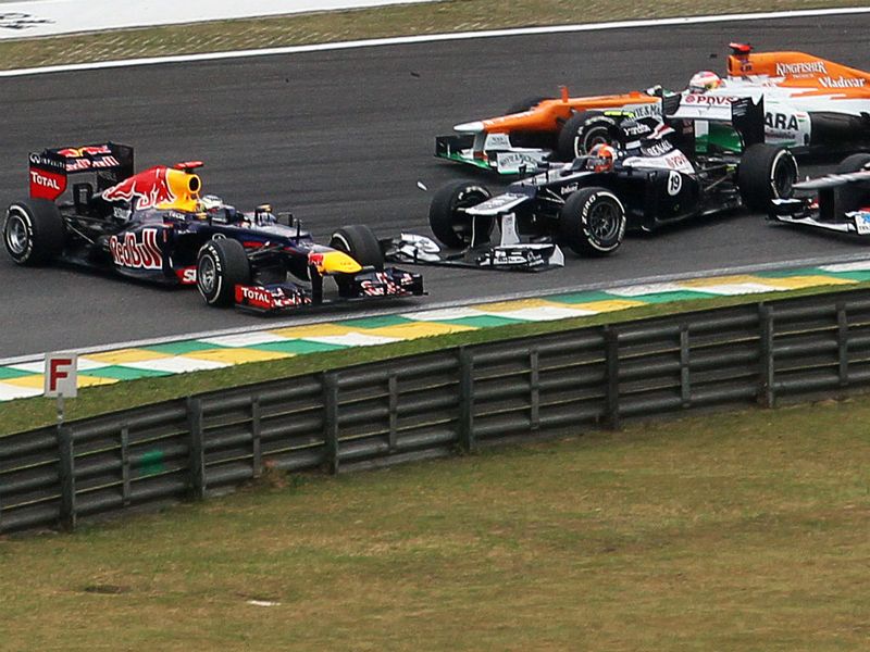 Sebastian Vettel makes contact with Bruno Senna